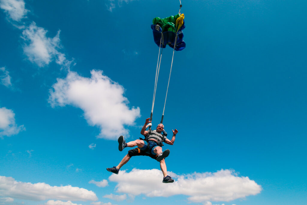 Tandem skydivers under an open parachute