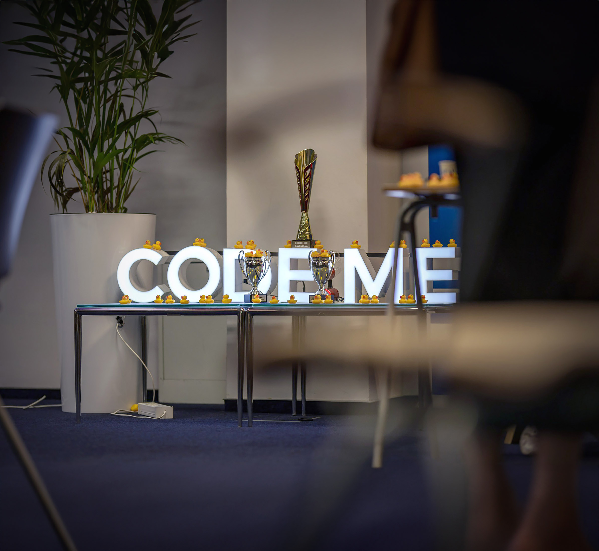 Illuminated CODE:ME letters on a stage