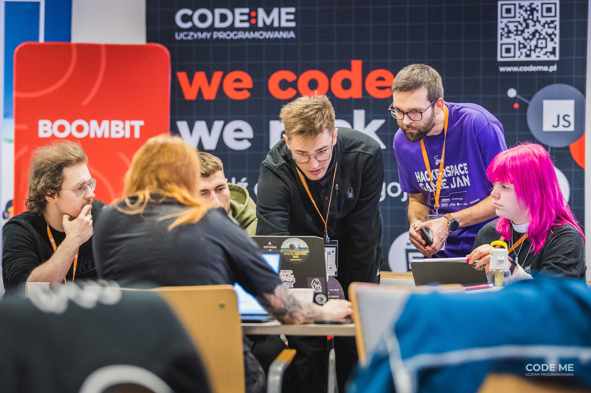 Students working on laptops at a CODE:ME hackathon