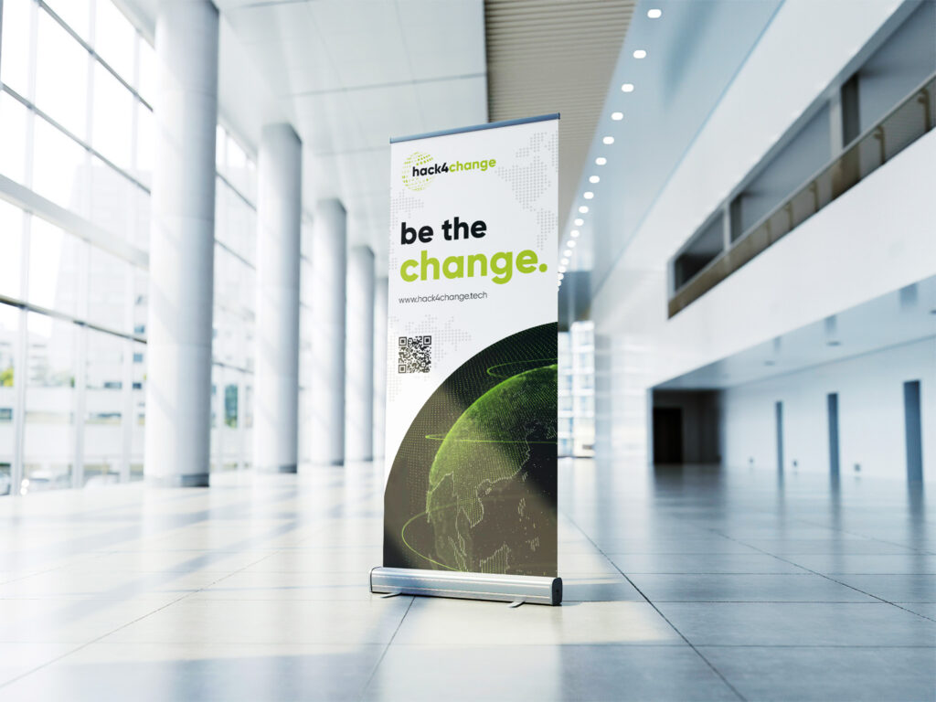 hack4change "be the change" roll-up banner in a bright hallway