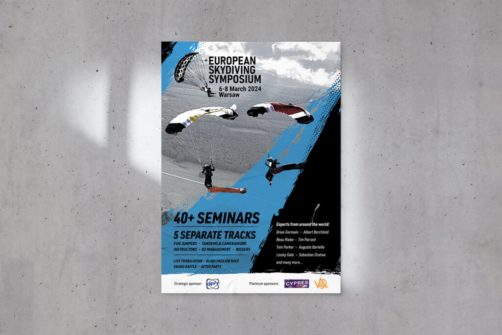 European Skydiving Symposium poster with wingsuit flyers on a concrete wall