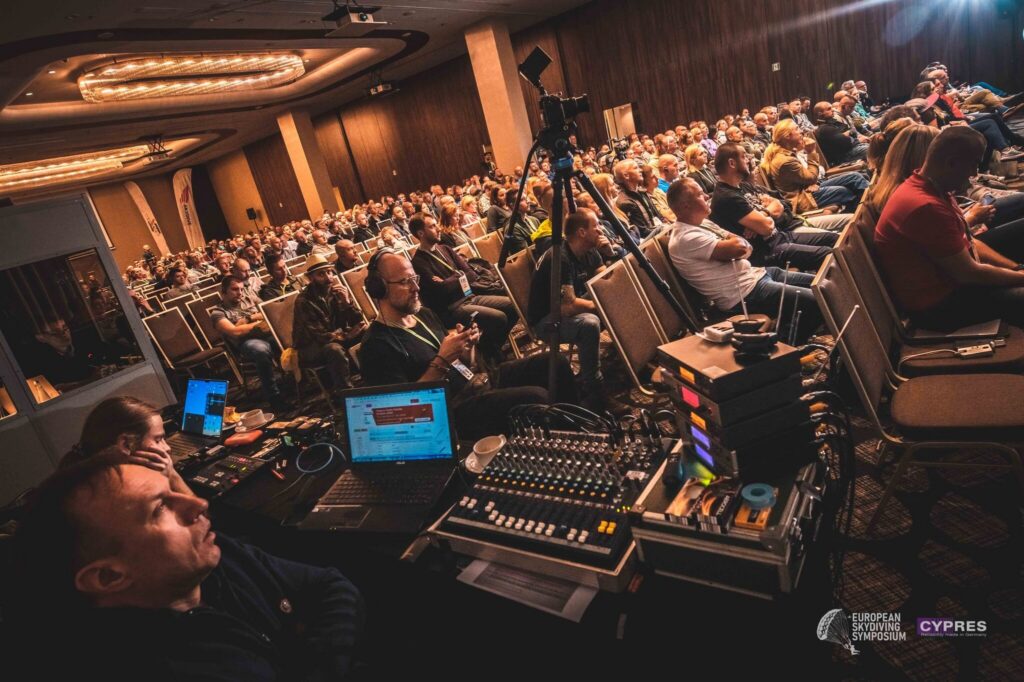 Full conference hall at the European Skydiving Symposium, seen from the sound desk