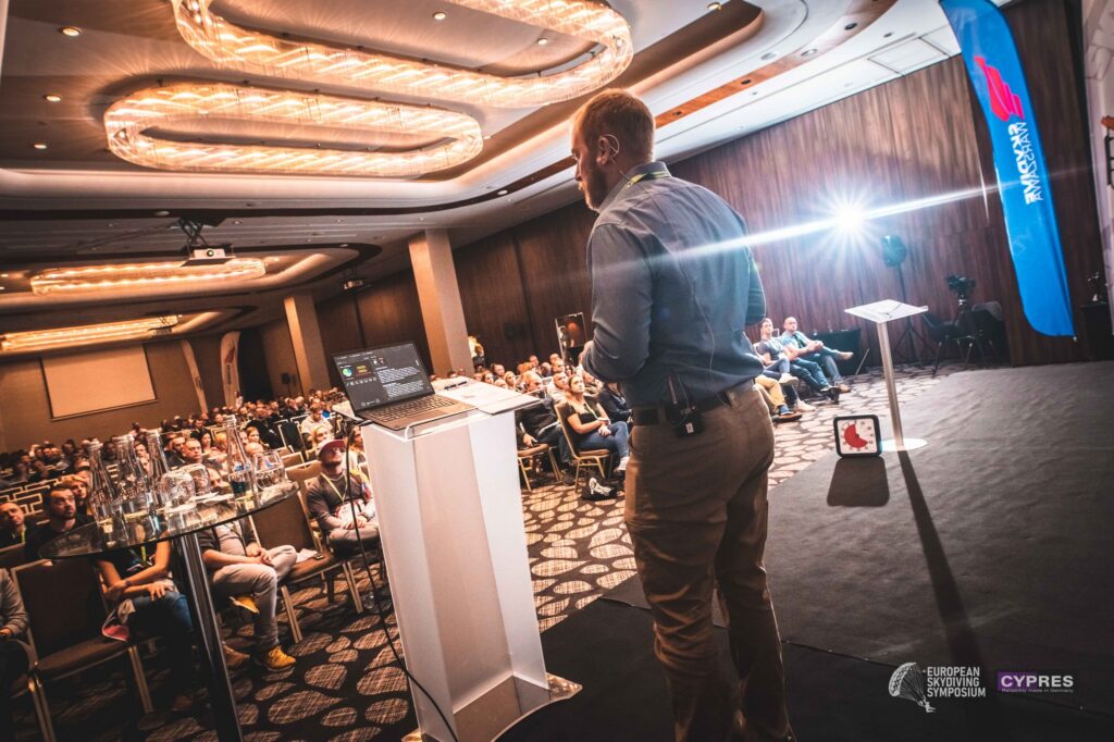 Speaker presenting to a full room at the European Skydiving Symposium