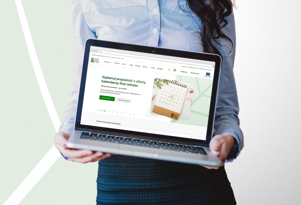 Woman holding a laptop with the FKD website