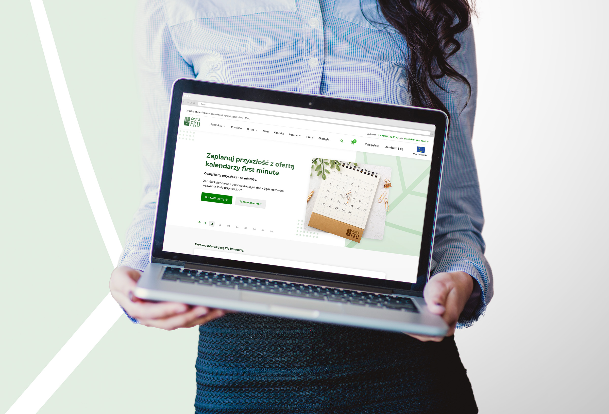 Woman holding a laptop with the FKD website