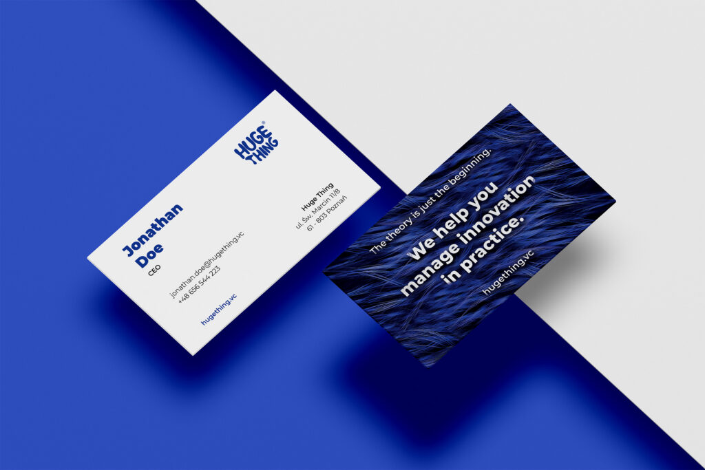 Huge Thing business cards on a blue background