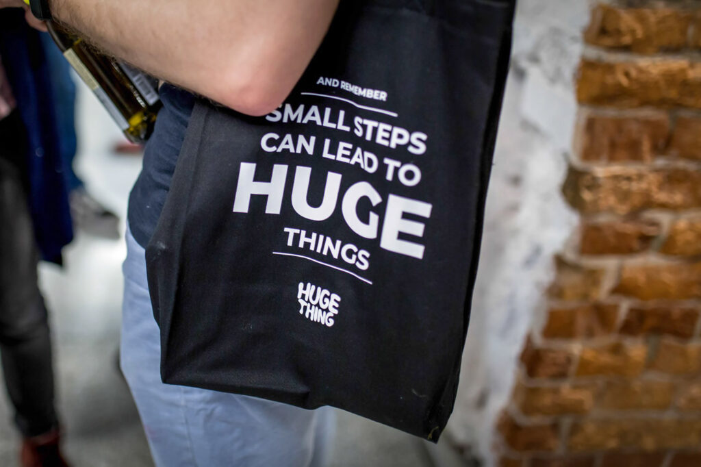 Black tote bag: "Small steps can lead to huge things"