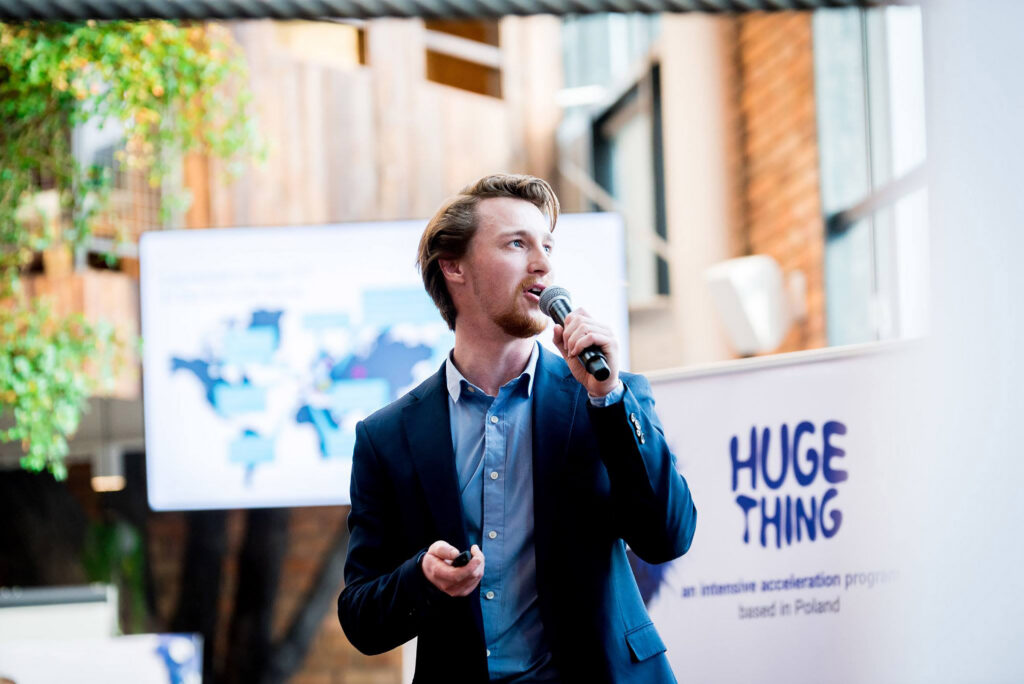 Speaker with a microphone at a Huge Thing event