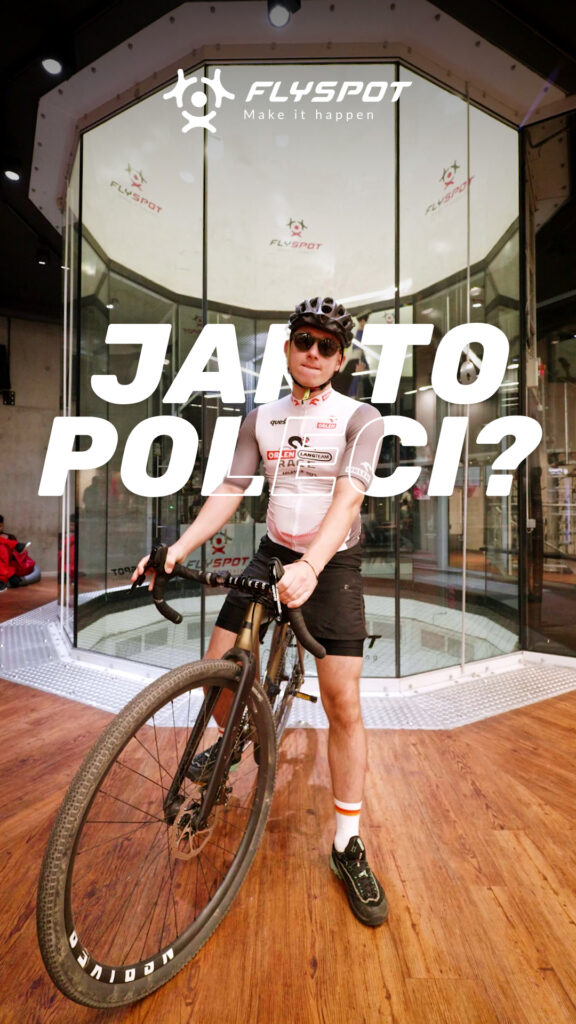 "Jak to poleci?" video cover: a man with a bicycle in front of the Flyspot wind tunnel