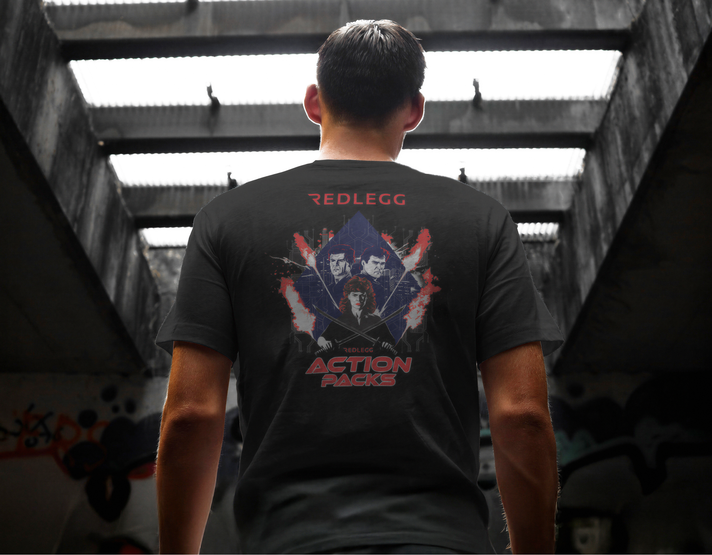 Man seen from behind in a black RedLegg T-shirt with an "Action Packed" print