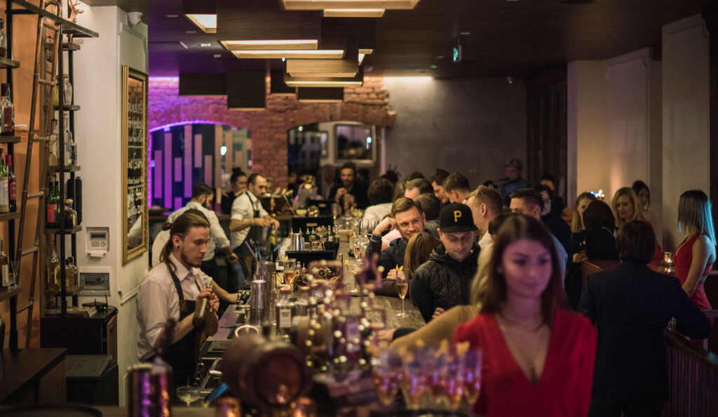 Crowded bar at an evening event at Eliksir