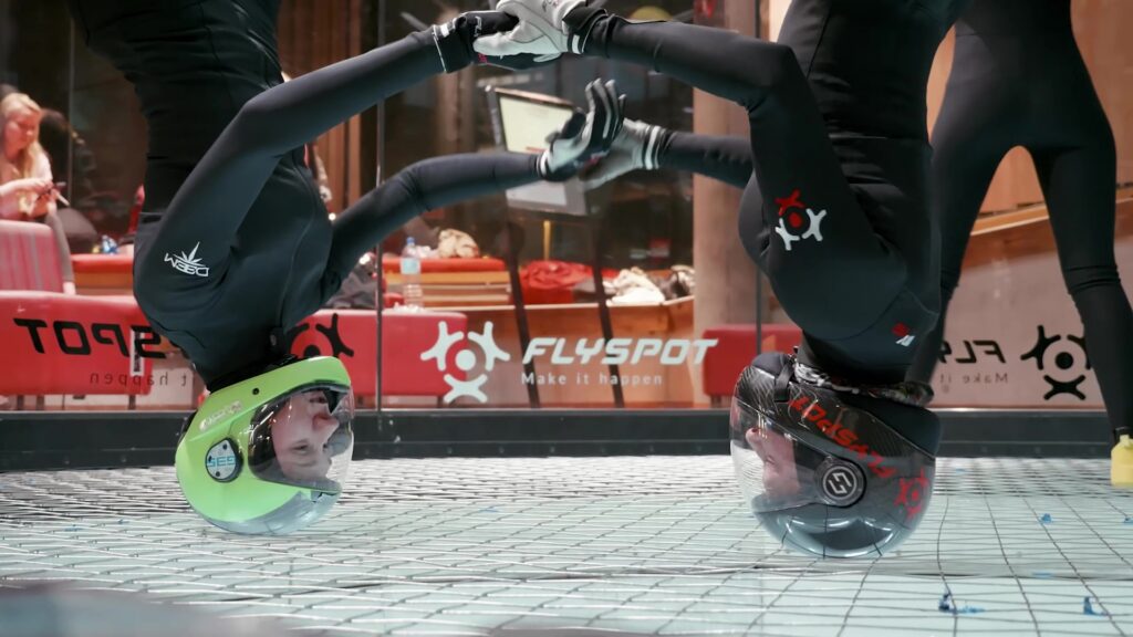 Two flyers upside down in the wind tunnel, close-up