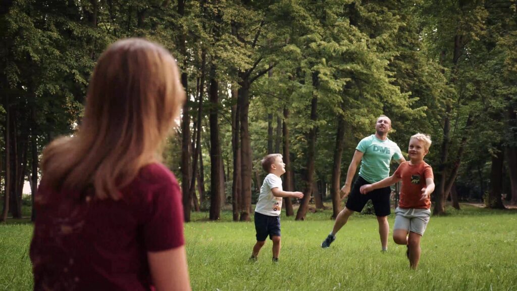 Children running across a park lawn, still from a Flyspot ad