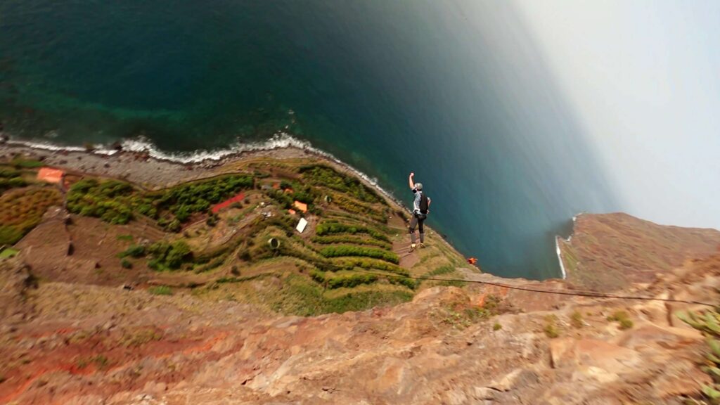 BASE jumper on the edge of a sea cliff at Cabo Girão, Madeira