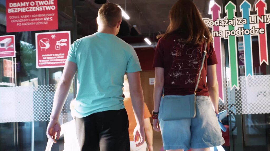 Couple walking into the Flyspot wind tunnel lobby