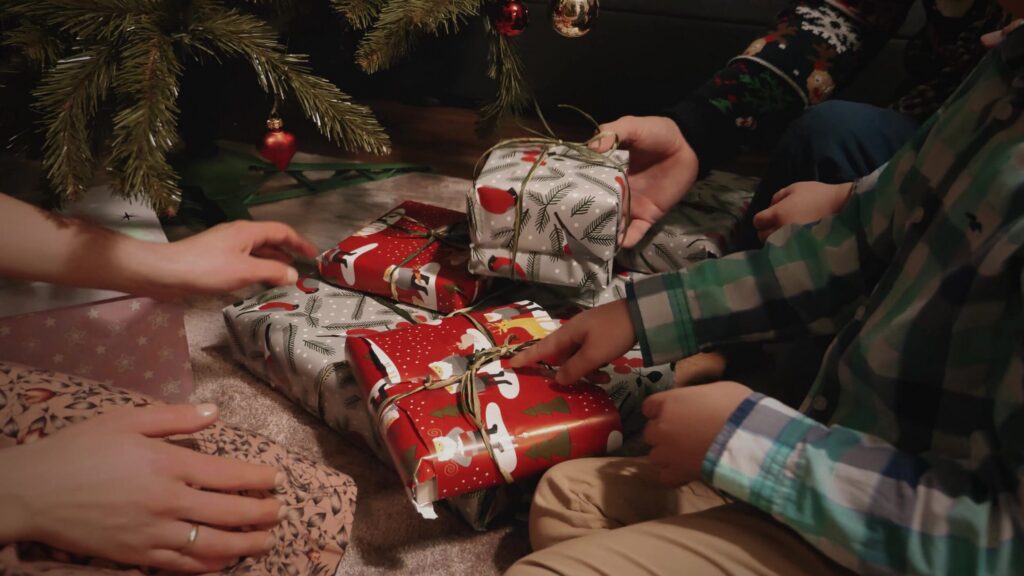 Hands unwrapping Christmas presents, still from a Flyspot gift voucher ad
