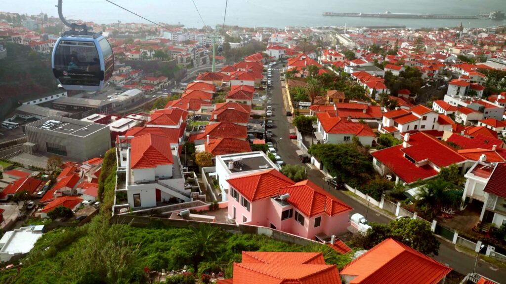 Cable car above red-roofed houses, Madeira