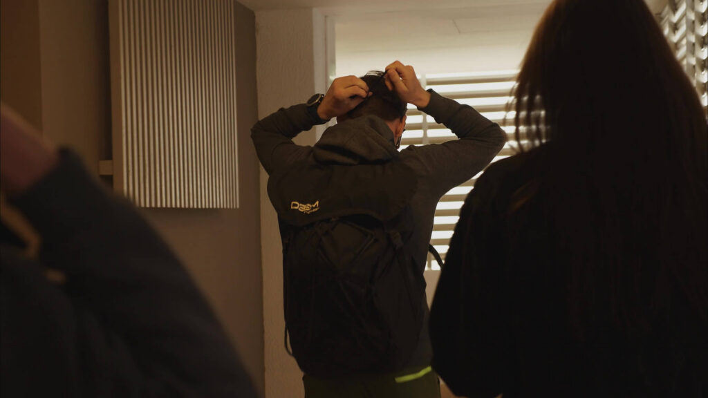 BASE jumper putting on a helmet indoors before a jump