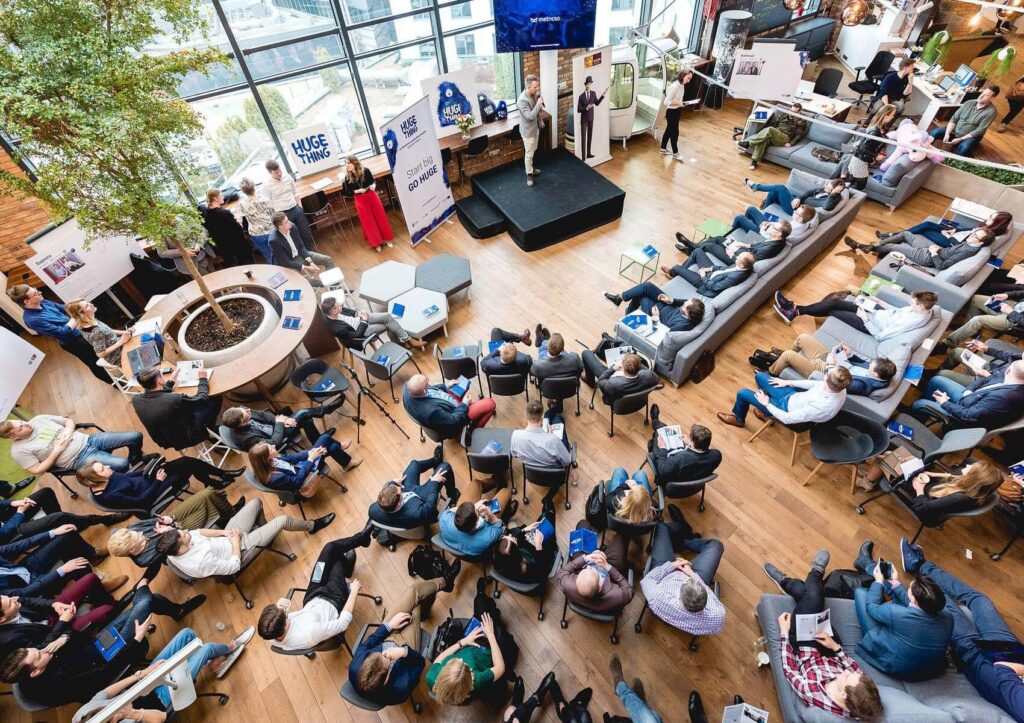 Overhead view of a crowded Huge Thing event in a bright atrium