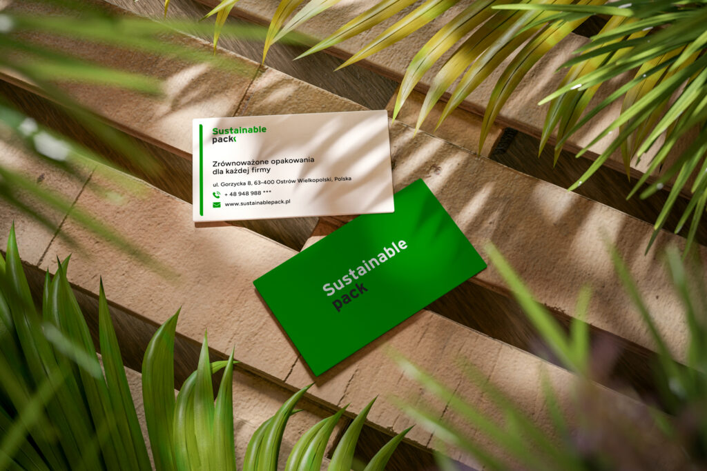 Sustainable Pack business cards on wooden planks among plants