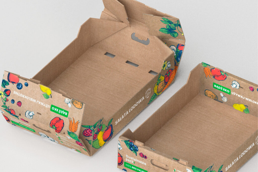 Two cardboard produce trays printed with fruit and vegetable illustrations