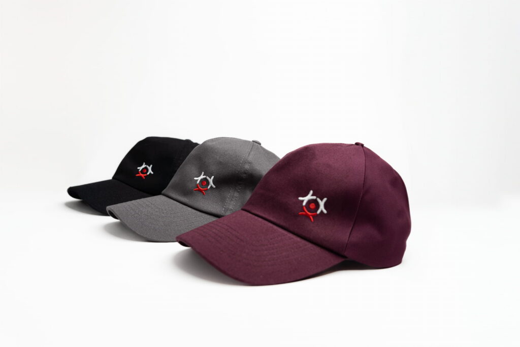 Three Flyspot baseball caps in black, grey and burgundy